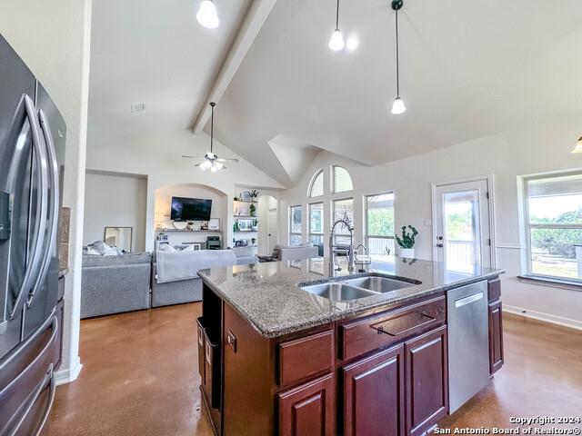 320 Mill Run, New Braunfels, TX 78132 - kitchen featuring a sink, stainless steel appliances, a center island with sink, finished concrete flooring, and decorative light fixtures