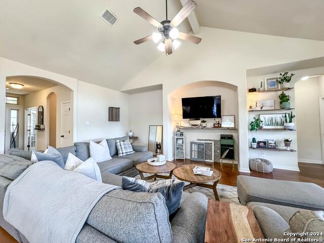 320 Mill Run, New Braunfels, TX 78132 - living area with a ceiling fan, arched walkways, wood finished floors, beam ceiling, and high vaulted ceiling