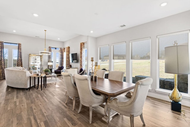 dining space with recessed lighting, wood finished floors, and visible vents