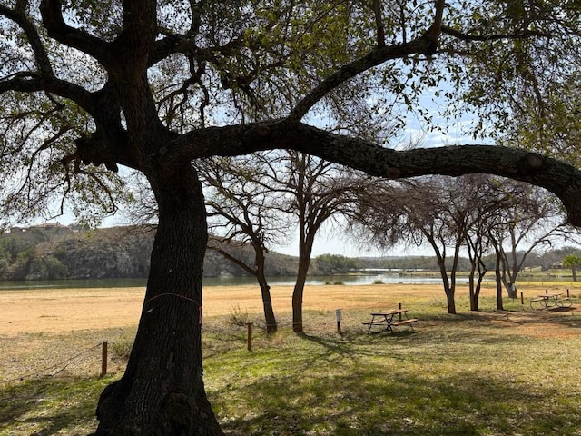 view of home's community featuring a yard and a water view