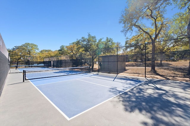 view of tennis court featuring fence