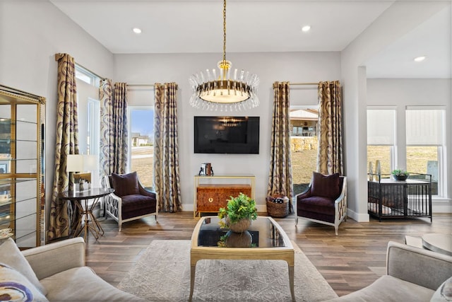 living area with recessed lighting, baseboards, and wood finished floors