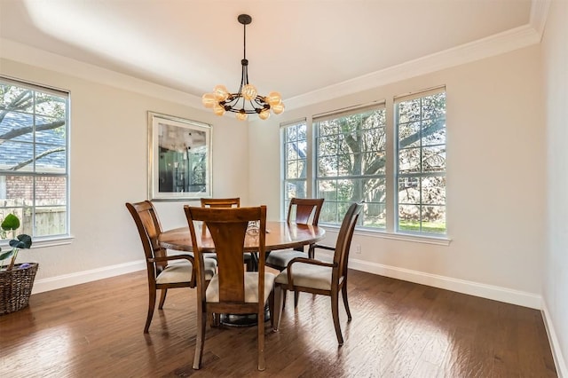 dining area featuring baseboards, a notable chandelier, dark wood-style floors, and crown molding