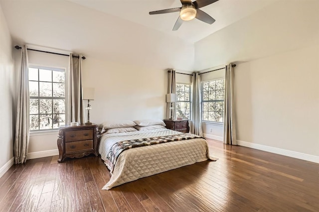 bedroom featuring baseboards, lofted ceiling, ceiling fan, and hardwood / wood-style flooring