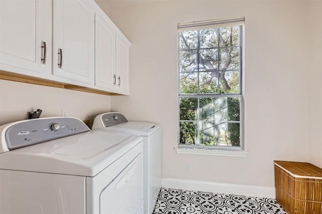 laundry area featuring tile patterned floors, cabinet space, baseboards, and washer and clothes dryer