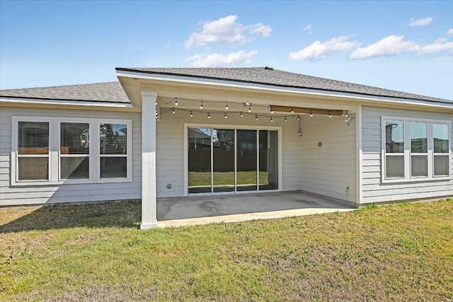 rear view of property featuring a patio area and a yard