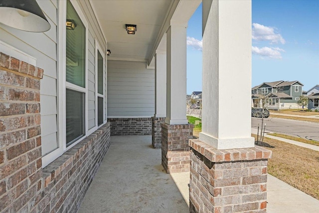 view of patio with a residential view and a porch