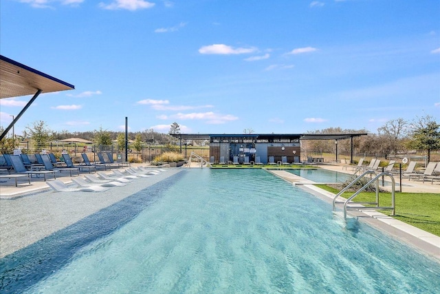 pool with a patio and fence