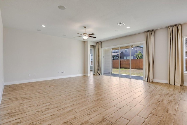 spare room with visible vents, ceiling fan, baseboards, and light wood-style floors