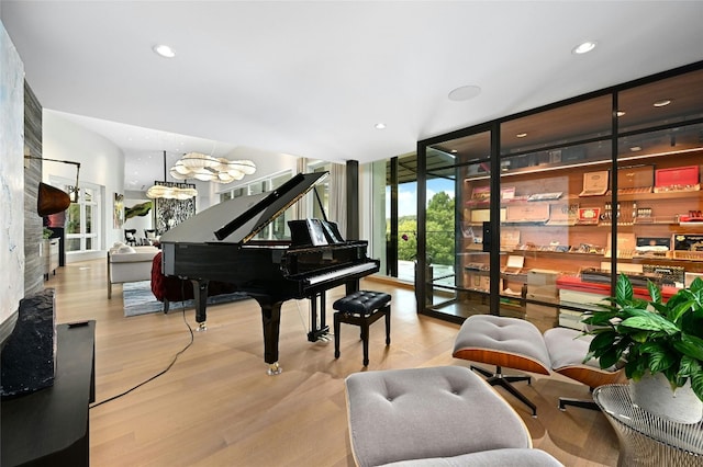 sitting room featuring a wall of windows, wood finished floors, and recessed lighting