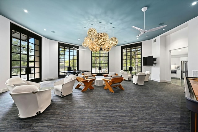 living room with recessed lighting, a healthy amount of sunlight, visible vents, and baseboards