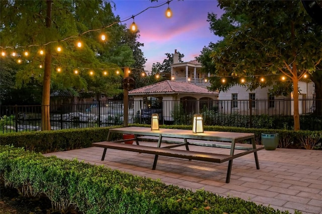 view of home's community with a patio area and fence