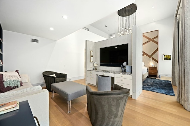 living room with recessed lighting, visible vents, and light wood finished floors