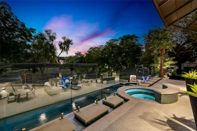 outdoor pool featuring an in ground hot tub and a patio