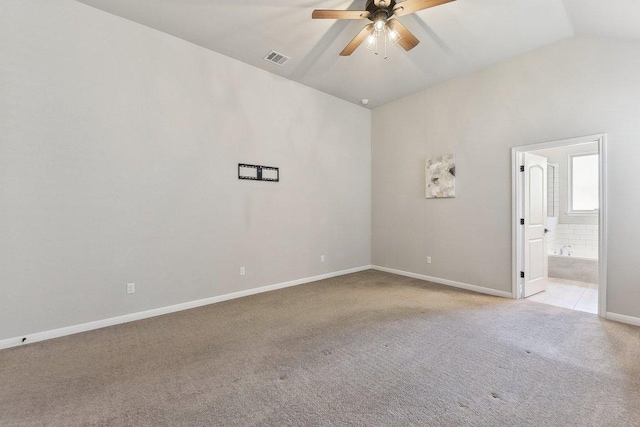 unfurnished room with visible vents, light carpet, baseboards, ceiling fan, and vaulted ceiling