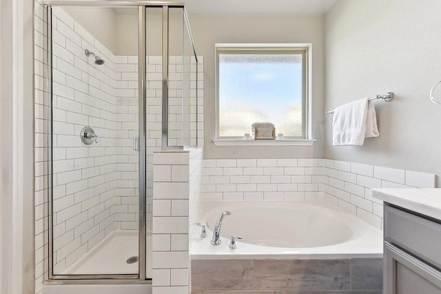 full bath with a stall shower, vanity, and a bath