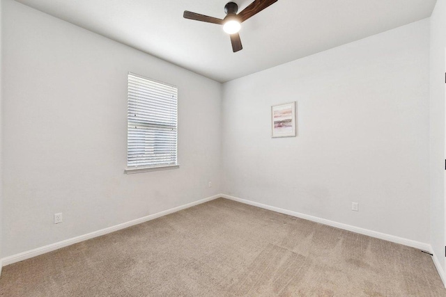 empty room with baseboards, carpet floors, and ceiling fan