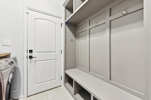 mudroom featuring light tile patterned flooring and washer and dryer