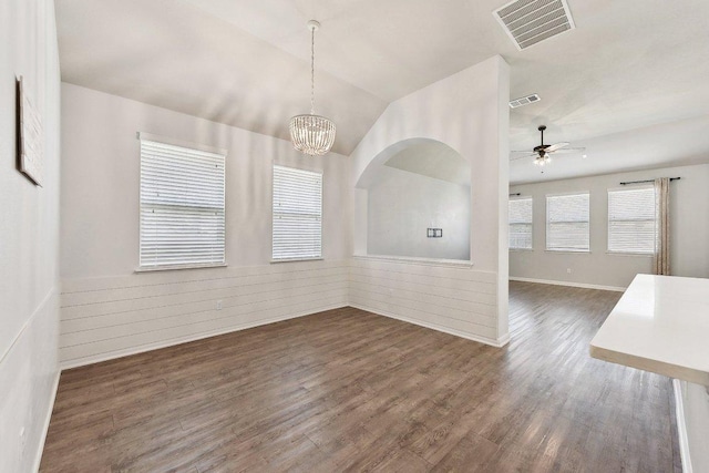 unfurnished dining area with visible vents, lofted ceiling, dark wood finished floors, and ceiling fan with notable chandelier