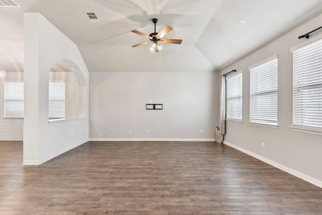 empty room featuring baseboards, lofted ceiling, a ceiling fan, and dark wood-style flooring