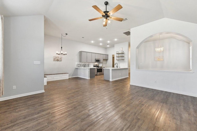 unfurnished living room featuring visible vents, ceiling fan with notable chandelier, dark wood finished floors, arched walkways, and lofted ceiling