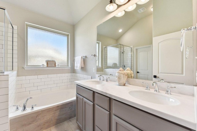 bathroom featuring a shower stall, a bath, visible vents, and a sink