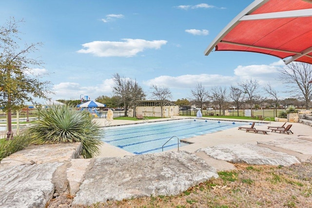 pool featuring a patio and fence