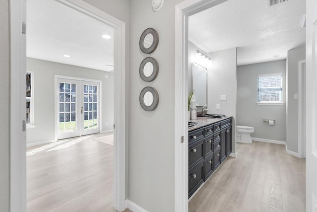 5213 Summerset Trl, Austin, TX 78749 - full bath with wood finished floors, double vanity, french doors, and recessed lighting