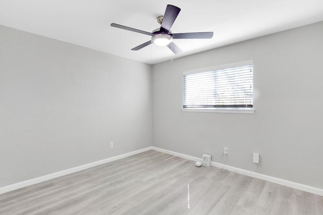 unfurnished room with ceiling fan, light wood-type flooring, and baseboards