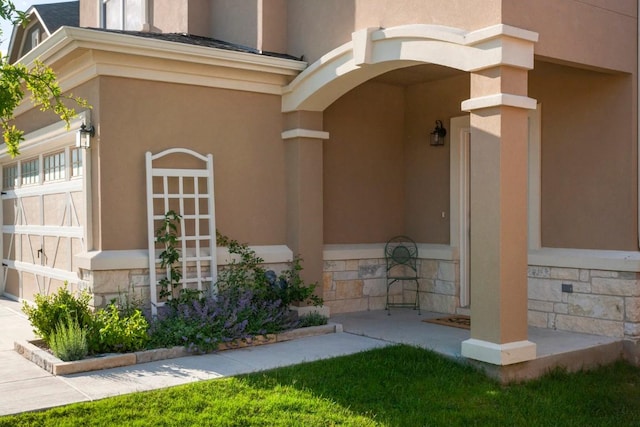 entrance to property featuring stone siding and stucco siding