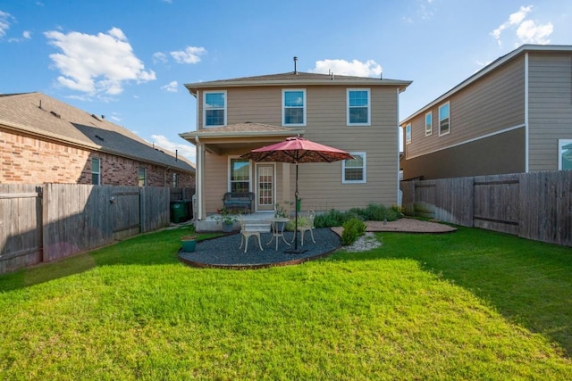 back of house featuring a patio, a lawn, and a fenced backyard