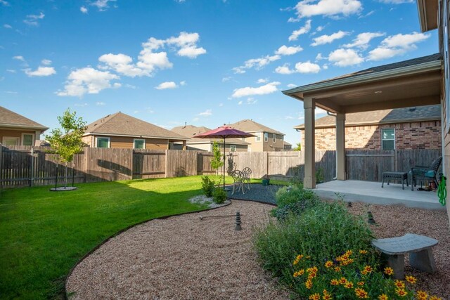 view of yard with a patio area, a residential view, and a fenced backyard