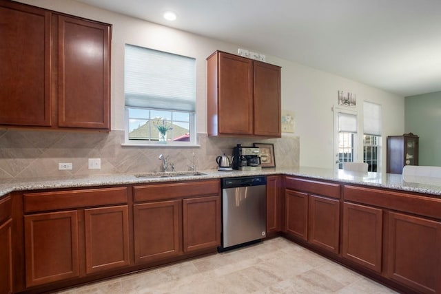 kitchen with a sink, decorative backsplash, brown cabinets, and dishwasher