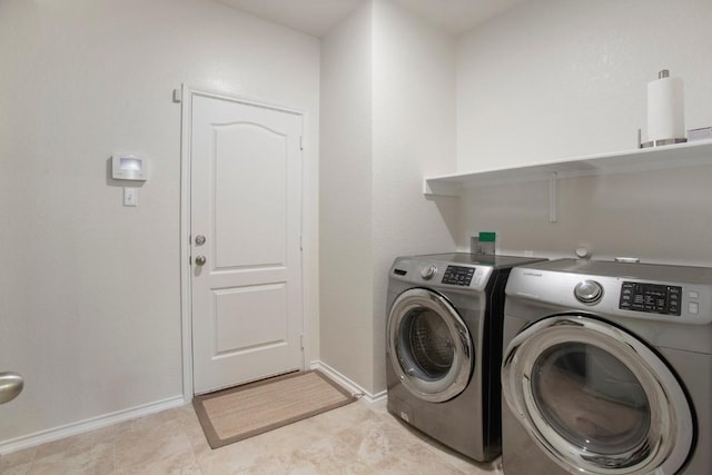 laundry room with baseboards, independent washer and dryer, and laundry area