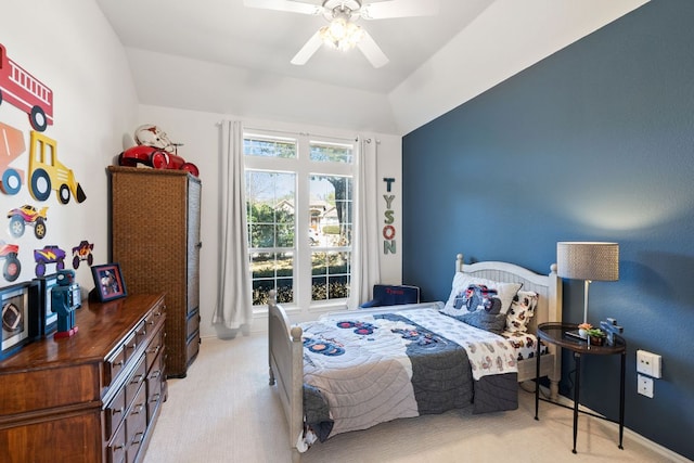 bedroom with light carpet, lofted ceiling, and a ceiling fan