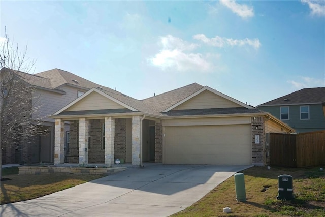 view of front of house with stone siding, fence, concrete driveway, an attached garage, and a shingled roof