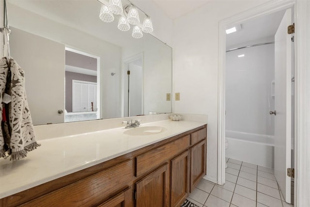 bathroom featuring tile patterned flooring, a chandelier, toilet, shower / bathing tub combination, and vanity