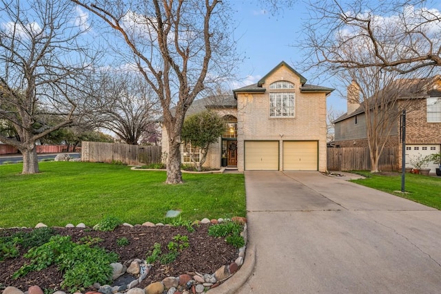 traditional-style house featuring a front yard, fence, driveway, an attached garage, and brick siding