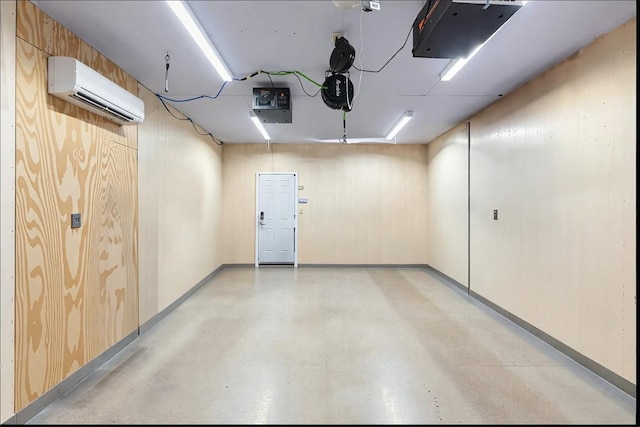 garage with a garage door opener, baseboards, and a wall mounted AC