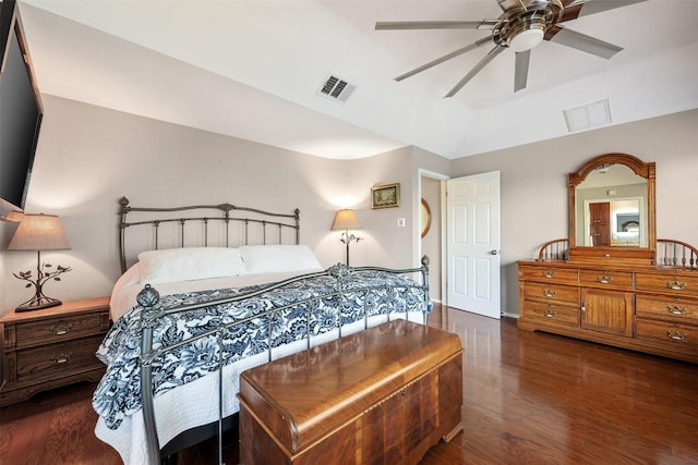 bedroom featuring visible vents, lofted ceiling, wood finished floors, and a ceiling fan