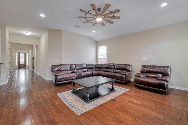 living room featuring baseboards, lofted ceiling, hardwood / wood-style floors, and a ceiling fan