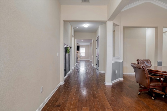 corridor with dark wood finished floors, baseboards, and visible vents