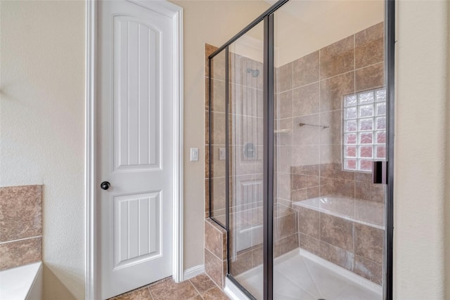 full bathroom with a stall shower and tile patterned floors