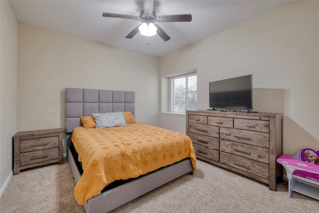 carpeted bedroom with baseboards and a ceiling fan
