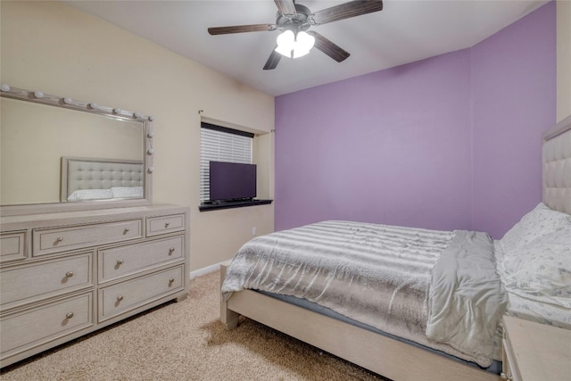 bedroom with ceiling fan, baseboards, and light carpet