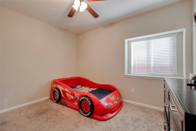 bedroom featuring baseboards, ceiling fan, and carpet flooring