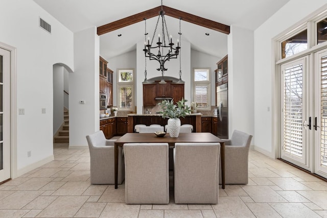 dining space with stone tile floors, visible vents, high vaulted ceiling, arched walkways, and beamed ceiling