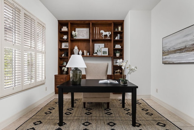 office area with light tile patterned floors and baseboards