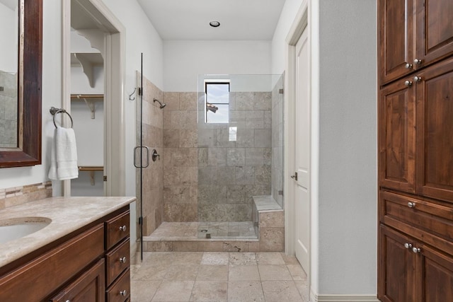 full bathroom with vanity and a tile shower