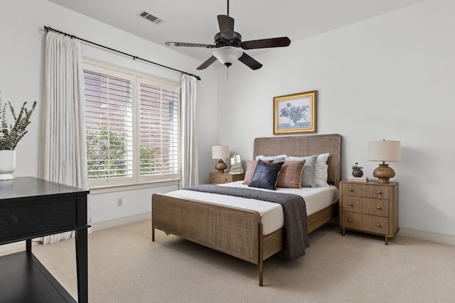 bedroom featuring visible vents, light colored carpet, a ceiling fan, and baseboards